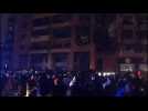 People gather in the street at site of explosion in Beirut's southern suburbs
