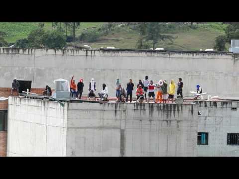 Inmates on roof of Ecuador prison as police officers held hostage inside