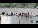 Inmates on roof of Ecuador prison as police officers held hostage inside