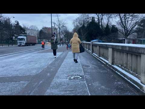 Thin layer of snow covers Paris outskirt for morning commute