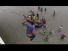 Migrants jump into river from border bridge to reach Mexico