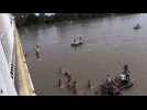 Migrants jump from the Guatemala-Mexico border bridge into river