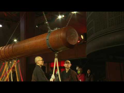 Monks strike temple bell to ring in the Year of the Dragon