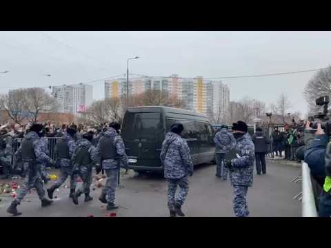 Navalny mourners throw flowers on hearse leaving church