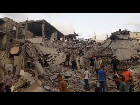 Gazans search through the rubble following Israeli strike on Deir El-Balah