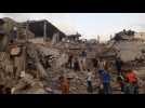 Gazans search through the rubble following Israeli strike on Deir El-Balah