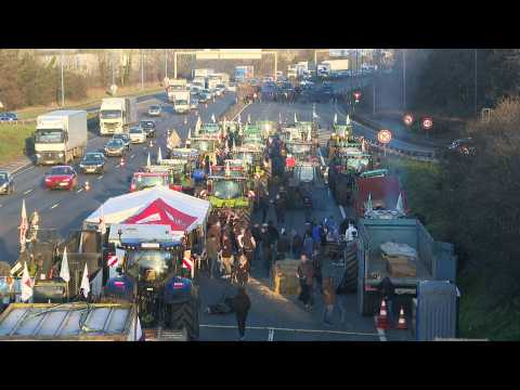 French farmers block motorway near Paris, face police roadblock