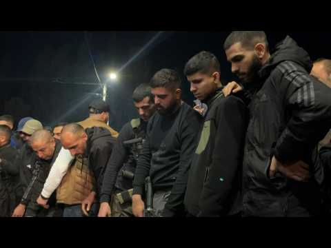 Palestinians gather at the funeral of three people killed in a West Bank Israeli strike