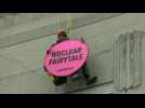 Greenpeace activist hangs from building hosting nuclear summit in Brussels