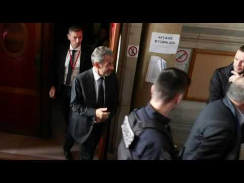 Sarkozy leaves French courtroom after ruling to lighten prison sentence