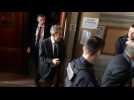 Sarkozy leaves French courtroom after ruling to lighten prison sentence