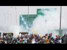Indian police fire tear gas at farmers in a highway standoff