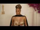 Laverne Cox poses for photographs on the Oscars red carpet