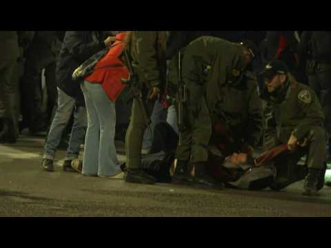 Israeli forces evacuate a man from an anti-government demonstration in Tel Aviv