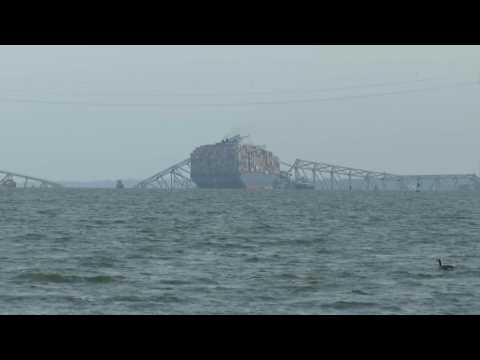 Baltimore's collapsed Key Bridge and container ship underneath it