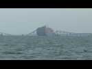 Baltimore's collapsed Key Bridge and container ship underneath it