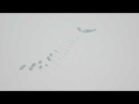 Planes parachute aid into Gaza, seen from Israel