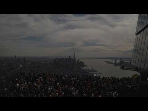 People gather in Manhattan to see the partial solar eclipse