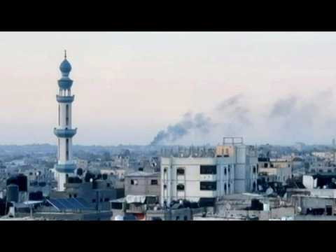 Smoke rises from southern Gaza as the sun sets on the last evening of Ramadan
