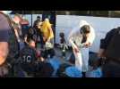Ocean Viking: migrants alight from bus at welcome site