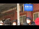 Beijing residents queue outside clinic as infections soar