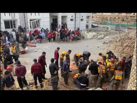 Emergency workers search rubble after blast at Pakistan mosque kills 33, including police officers