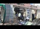 People clear rubble day after twin blasts rock Somali capital