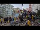 People clear rubble from buildings destroyed by quake in southern Turkey