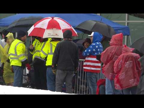 Supporters line up in the rain ahead of Trump's rally in New Hampshire