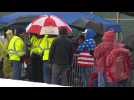 Supporters line up in the rain ahead of Trump's rally in New Hampshire
