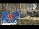 Migrants gather behind barbed wires at the border between Turkey and Greece