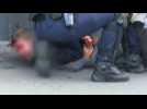 Images of an injured man being detained during yellow vest protest in Paris