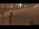 Lebanese forces use water cannons during clashes outside Parliament