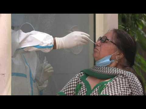 Indians at Covid-19 testing centre as infections hit new record
