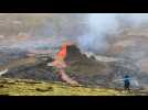 Red lava continues to spew from Icelandic volcano