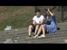 In Paris, tourists and Parisians enjoy the hot day