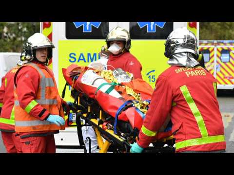 Firefighters evacuate wounded person in Paris after knife attack