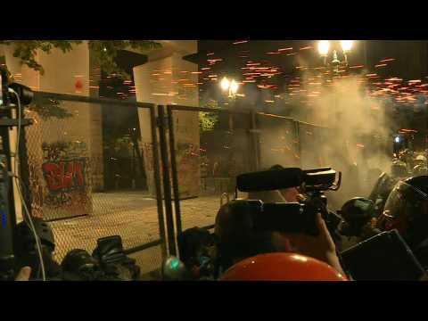 Tear gas fired as protesters try to break down courthouse fence in Portland