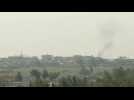 Smoke billows over the Syrian town of Tell Abyad, located just across the border with Turkey
