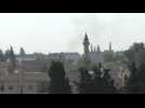 Smoke billows over Syrian border town of Tell Abyad as strikes sound