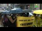 Soaked Hong Kong protesters again defy mask ban in huge rally