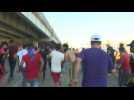 Iraqi protesters run to take cover in the capital Baghdad