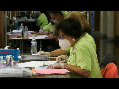 Mail-in ballots are being counted in battleground state of Wisconsin