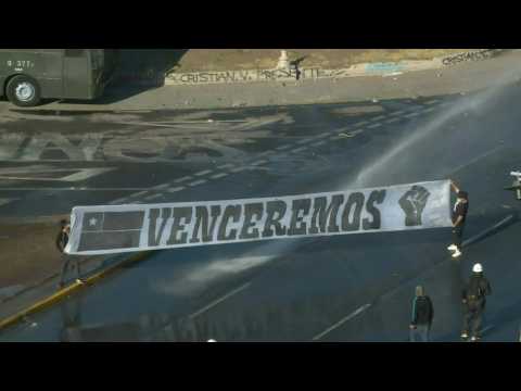 Chile police disperse protesters with water cannons as voting continues