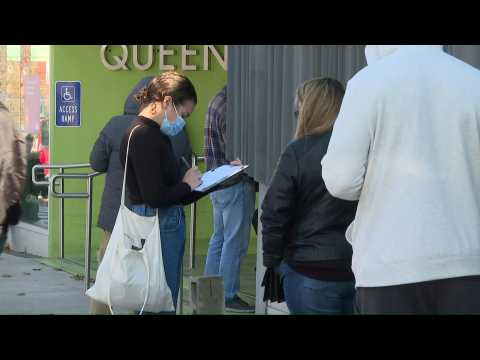 New Yorkers line up outside a Covid-19 test site in Queens