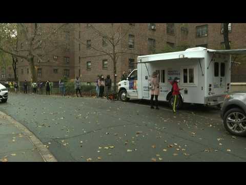 New Yorkers line up outside a Covid-19 test site in Brooklyn