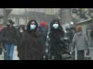 Locals bundle up as snow falls on western France