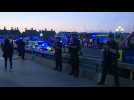 Police officers and firefighters clap in appreciation for healthcare workers on London's Thames
