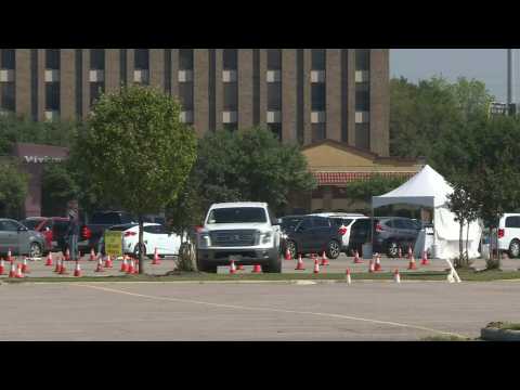 Cars line up at drive-through COVID-19 testing site in Houston