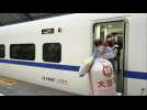 Coronavirus: Wuhan residents at train station as city exit ban lifted